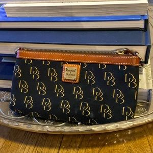 Dooney & Bourke fabric wristlet in black and gold monogram.